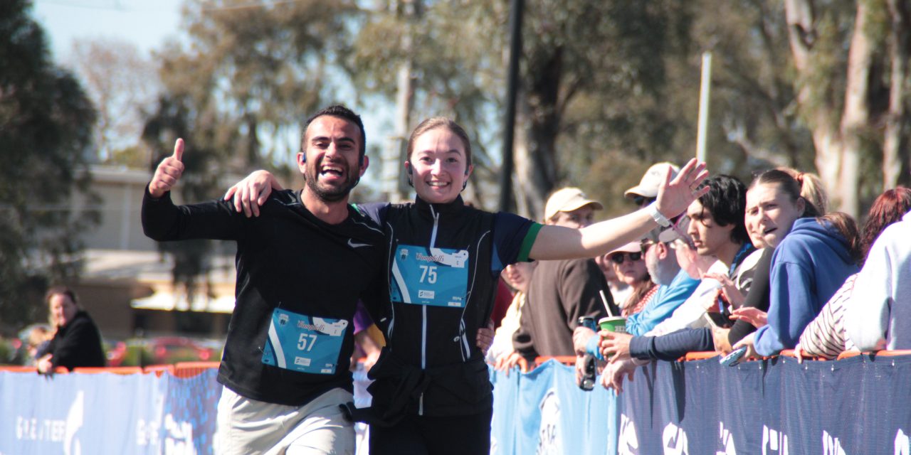 Runners smiling at the Shepparton finish line